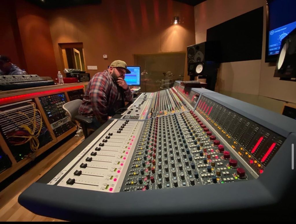 Elijah Stiner sitting at a soundboard.